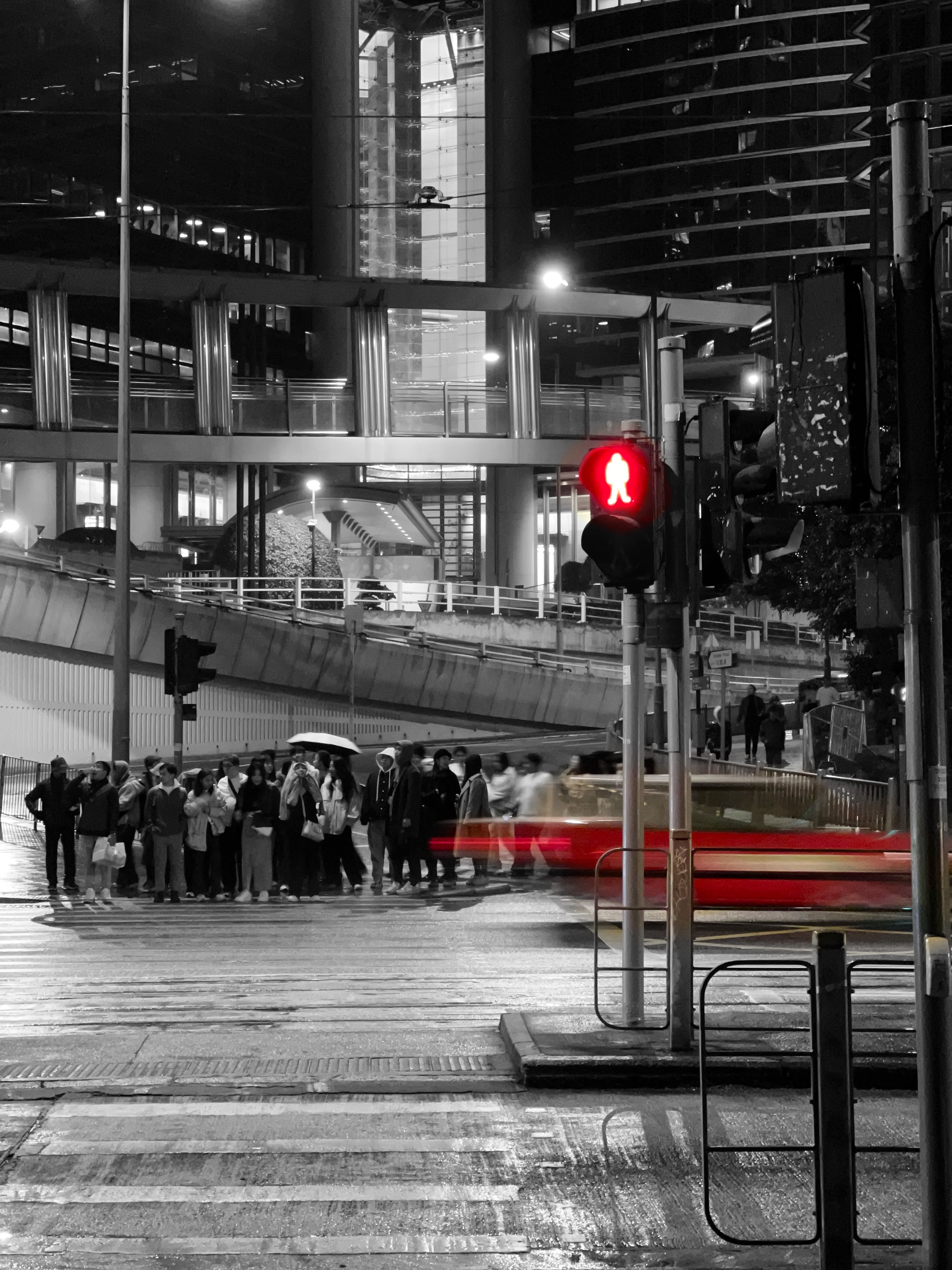 The nightfall in central with a taxi rushing by.